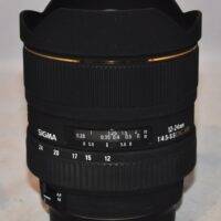 Sigma EX 12-24mm f4.5-f5.6 DG HSM. Includes original hood, original caps, and case.